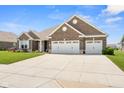 Stunning brick home with a spacious three-car garage, expansive driveway, and well-kept front yard at 4659 W Otway Ln, New Palestine, IN 46163