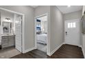 Hallway view with wood floors and neutral paint leading to a bathroom and a bedroom at 5151 Nettleton Way, Avon, IN 46123