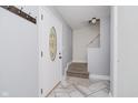 Bright entryway with light gray walls, modern tile floors, and an elegant front door with decorative glass at 5236 Honey Comb Ln, Indianapolis, IN 46221
