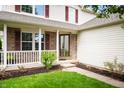 Inviting front porch with white railings and brick accents enhance the curb appeal at 6026 Pennyworth Cir, Indianapolis, IN 46203