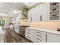 Bright kitchen with white cabinets, stainless steel appliances, marble countertops, and stylish backsplash at 6230 E 56Th St, Indianapolis, IN 46226