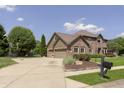 Stately brick home with attached garage and long driveway at 7430 Franklin Parke Woods, Indianapolis, IN 46259