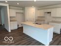Spacious kitchen features a large center island with sink and countertop seating, and white cabinetry at 7517 Big Bend Blvd, Camby, IN 46113