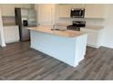 Modern kitchen with stainless steel appliances, an island with sink, white cabinets, and granite countertops at 7605 Big Bend Blvd, Camby, IN 46113
