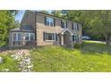 Inviting two-story brick home with a bay window and landscaped yard on a sunny day at 80 E College Ave, Martinsville, IN 46151