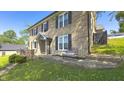 Attractive brick home featuring well-maintained landscaping and outdoor seating on a sunny day at 80 E College Ave, Martinsville, IN 46151