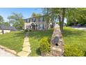 Brick home on a hill with a landscaped yard, mailbox, and a charming walkway at 80 E College Ave, Martinsville, IN 46151