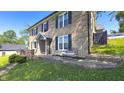 Brick home exterior showcasing a cozy seating area and well-maintained lawn at 80 E College Ave, Martinsville, IN 46151