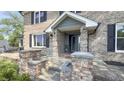 Inviting front entrance with brick pillars and covered porch at 80 E College Ave, Martinsville, IN 46151