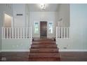 Grand entryway featuring hardwood floors, a staircase, and a charming front door at 858 Cedar Wood, Carmel, IN 46032