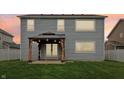 Spacious backyard featuring a covered patio with string lights and a well-maintained lawn at 951 Parker Ln, Westfield, IN 46074