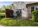 Relaxing outdoor patio with comfortable seating and a view of the lush backyard at 9572 Maple Way, Indianapolis, IN 46268