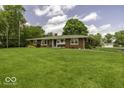 A well-maintained ranch-style home with a tidy lawn and mature trees at 1190 W Jefferson St, Franklin, IN 46131