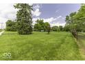 A view of the long lawn and tree-lined property at 1190 W Jefferson St, Franklin, IN 46131