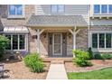 Close up of the front entrance of an elegant two story home with brick exterior and covered front porch at 12082 Old Stone Dr, Indianapolis, IN 46236