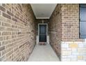 Covered entryway showcases the brick facade and leads to a black front door at 1270 Shaw Ln, Shelbyville, IN 46176