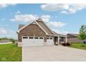 Charming brick home featuring a large three car garage and well-manicured lawn at 1270 Shaw Ln, Shelbyville, IN 46176