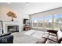 Bright living room featuring a fireplace, large windows, and comfortable sofas for Gathering and guests at 12832 Broncos Dr, Fishers, IN 46037