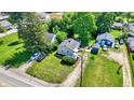 Aerial shot showcasing a property with a well-manicured lawn, multiple parked cars, and a shed in the backyard at 1515 S Emerson Ave, Indianapolis, IN 46203