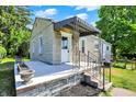 Charming single-story home with stone facade, covered entryway, and landscaped front yard at 1515 S Emerson Ave, Indianapolis, IN 46203