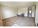 Bare living room with carpet and table with chairs at 1652 Sweetwater Ln, Greenfield, IN 46140