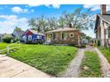 A single-Gathering home with a well-maintained lawn and a gravel driveway at 1852 N Warman Ave, Indianapolis, IN 46222