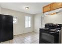 An eat-in kitchen with linoleum floors and black appliances at 1852 N Warman Ave, Indianapolis, IN 46222
