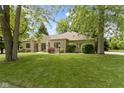 Spacious front yard with lush grass and mature trees providing shade and curb appeal at 1941 Orchard Ct, Carmel, IN 46280