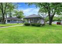 This home boasts a well-maintained lawn and quaint facade, creating a welcoming outdoor space at 2150 S Emerson Ave, Indianapolis, IN 46203
