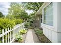 Charming walkway leads to a well-maintained home with manicured landscaping and white picket fence at 2807 Westleigh Dr, Indianapolis, IN 46268