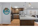 Stylish kitchen with wood cabinets, island with hanging lights, and stainless steel appliances at 2810 Bittersweet Blvd, Columbus, IN 47203
