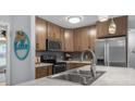 Updated kitchen features stainless appliances, wood cabinets, and modern countertops at 2810 Bittersweet Blvd, Columbus, IN 47203