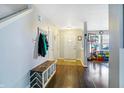 Welcoming entryway with coat rack, bench seating, and hardwood floors leading to the playroom at 3221 Holt St, Whiteland, IN 46184