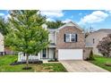 Attractive two-story home with a mix of brick and siding, complemented by mature landscaping at 3221 Holt St, Whiteland, IN 46184