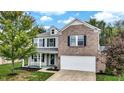 Charming two-story home with a brick and siding exterior, two car garage and a welcoming porch at 3221 Holt St, Whiteland, IN 46184