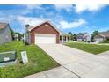 Single-Gathering home with attached garage, long driveway, and well-maintained lawn at 3222 Enclave Ln, Greenwood, IN 46143
