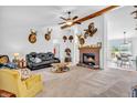 Cozy living room with a brick fireplace, ceiling fan, and comfortable seating at 3319 E 700 N, Whiteland, IN 46184