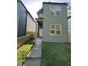 Two-story home with green siding, modern front door, and well-maintained front lawn and walkway at 39 N Walcott St, Indianapolis, IN 46201