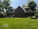 Large backyard with a deck, lush lawn, and brick home exterior at 4037 Oakleaf Dr, Zionsville, IN 46077