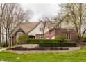 Charming brick home with manicured landscaping and mature trees, perfect curb appeal at 4037 Oakleaf Dr, Zionsville, IN 46077