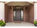 Elegant front entrance featuring a grand door with decorative glass and stylish lighting at 4037 Oakleaf Dr, Zionsville, IN 46077