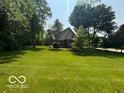 Beautiful, well-maintained grassy yard with mature trees in a quiet neighborhood at 4037 Oakleaf Dr, Zionsville, IN 46077