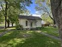 Charming home with mature trees providing shade and a welcoming curb appeal on a sunny day at 404 Pearl St, Pendleton, IN 46064