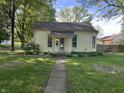 Traditional-style home with a well-kept lawn and sidewalk leading up to the front door at 404 Pearl St, Pendleton, IN 46064