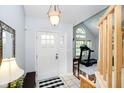 Bright foyer with white front door, tiled floor and sight lines into an adjacent room at 410 Wood Hollow Ct, Westfield, IN 46074