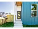 Inviting front entrance with a modern door and a glimpse of the beautifully designed home's interior at 43 N Walcott St, Indianapolis, IN 46201