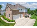 Spacious home featuring a three-car garage and a concrete driveway at 4368 W Eagle Trce, New Palestine, IN 46163