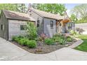 Charming exterior featuring a mix of brick and siding and manicured landscaping at 6110 Orinoco Ave, Indianapolis, IN 46227