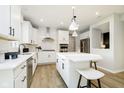 Modern kitchen with white cabinetry, stainless steel appliances, and a central island with seating at 6421 Springtide Ct, Plainfield, IN 46168