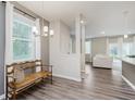Dining area with wood floors, neutral paint, and a view of the spacious living room at 6465 Wasco Dr, Whitestown, IN 46075